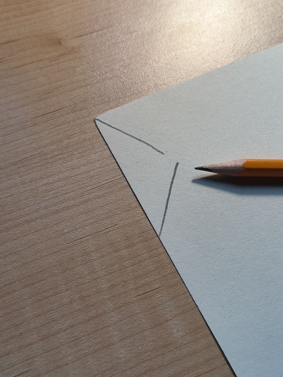 The activity begins with a simple pencil sketch on a piece of cardstock. This forms the base layout where the conductive elements will be placed—an initial design for a functional touch-based circuit.